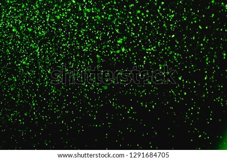 Abstract green powder splatted background,Freeze motion of red powder exploding/throwing green dust.


