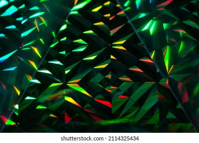 Abstract Green And Red Grainy Background With Light Triangles On Black Background.