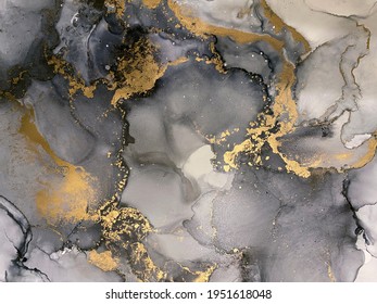 Abstract grey art with gold — black and white background with beautiful smudges and stains made with alcohol ink and golden pigment. Fluid art texture resembles watercolor or aquarelle.