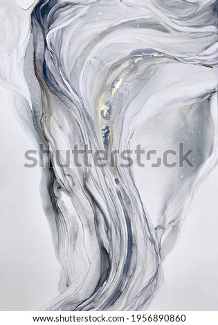 Abstract grey art with gold — marble background with beautiful smudges and stains made with alcohol ink and golden pigment. Black and white fluid texture resembles marble, watercolor or aquarelle.