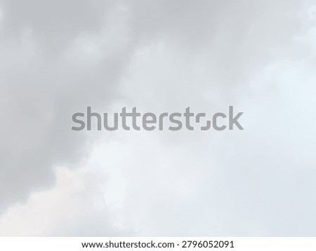 Abstract grey mist backdrop. Soft overcast sky and dense fog texture background. Pale gloomy weather wallpaper.