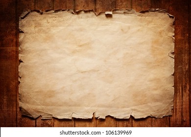 Abstract grunge background - old broken horizontal sheet of paper on brown wooden board
