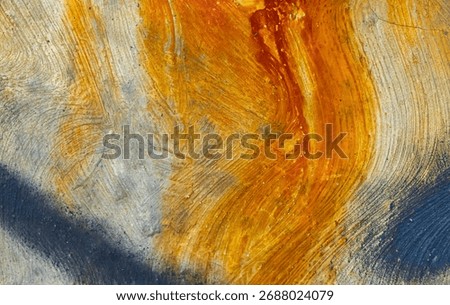 An abstract grunge texture background of a weathered concrete wall. Vibrant orange and yellow rust stains create a beautiful, flowing organic pattern on the rough surface