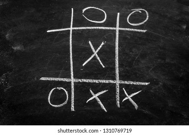 Abstract Hand Drawn O,X , Tic Tac Toe Game On A Chalkboard Or Black Background.