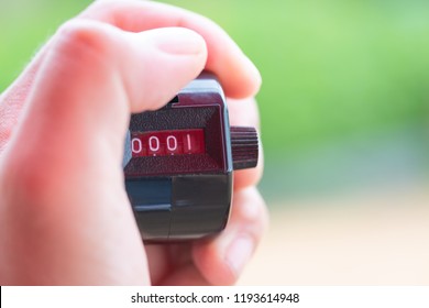 Abstract hand holding counting machine round of number for exercise and green nature background. - Powered by Shutterstock - Get 15% off with code: PIKWIZARD15