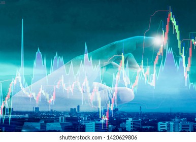 Abstract of hands of businessman, touching stock chart with background cityscape,concept of investment, exchanges in stock market, risks and fluctuations in financial business operation