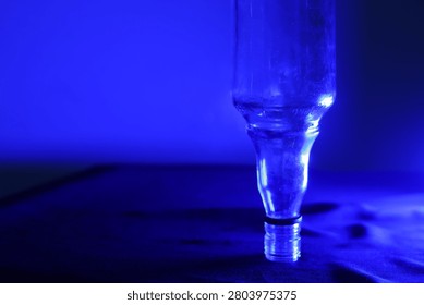 Abstract high dynamic range imaging of an upside-down bottle illuminated with red light