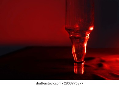 Abstract high dynamic range imaging of an upside-down bottle illuminated with red light