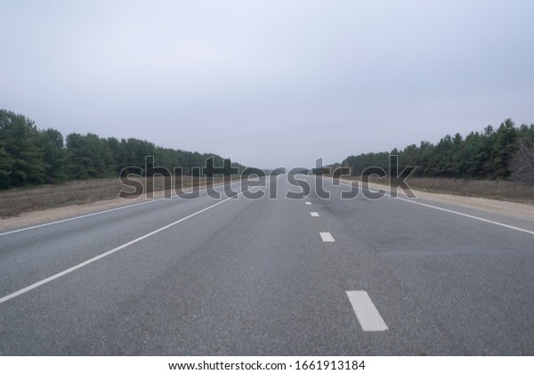 the abstract highway\
road in countryside in the fog rainy weather. danger driving,\
accident car crash