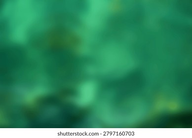Abstract horizontal blurred background featuring a rich emerald, turquoise, and mint green gradient with dark shadows and subtle yellow-green undercurrents.
