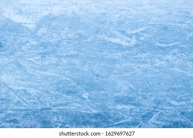 Abstract ice texture. Nature blue background. Traces of blades of skates on ice
