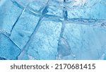 Abstract ice texture. A network of cracks on a piece of blue ice