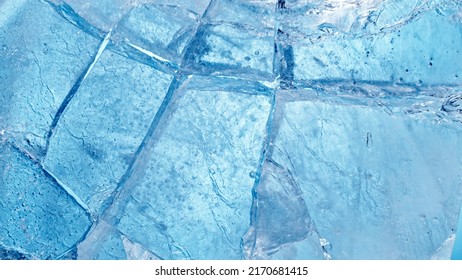 Abstract ice texture. A network of cracks on a piece of blue ice