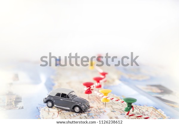 Abstract idea of rent a car. Small car on map.\
Abstract travel photo.