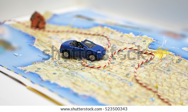 Abstract idea of\
rent a car. Small car on\
map.