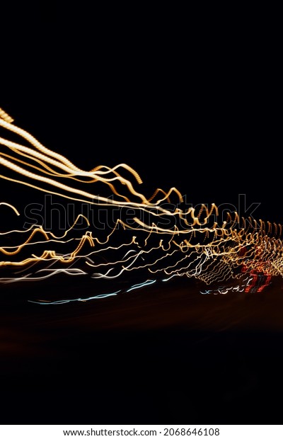 Abstract Illustration of dynamic car lights\
in night time. Long exposure car light\
trails.