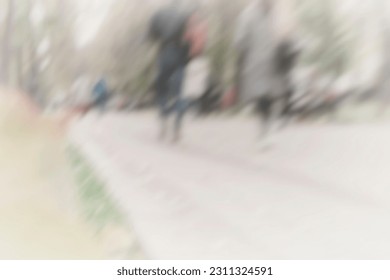 Abstract image of blurred people walking in  city park. Urban modern light background. Blur effect, copy space - Shutterstock ID 2311324591