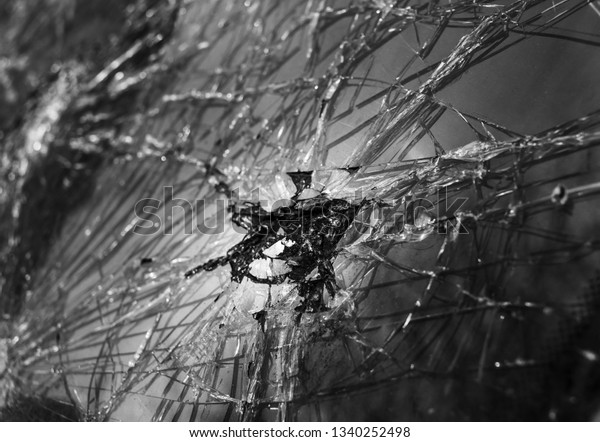 Abstract image of broken glass\
texture. Close-up broken car windshield. Broken and damaged\
car