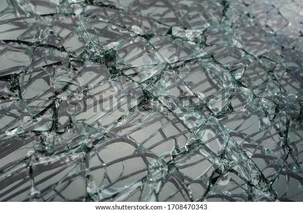 Abstract image of\
broken glass texture, background. Close-up broken car windshield.\
Broken and damaged car