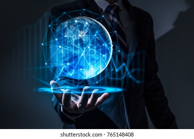 The abstract image of the business man hold the virtual hologram on hand and element of this image furnished by Nasa. the concept of communication network, internet of things and future life