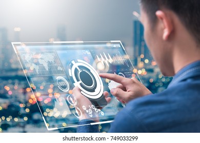 The abstract image of business man point to the hologram on his smartphone and blurred cityscape is backdrop. the concept of communication network, cyber security, internet of things and future life.