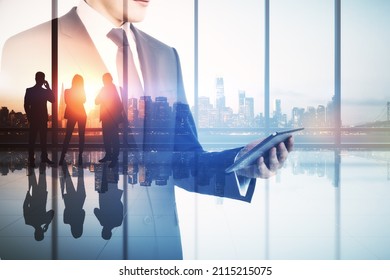 Abstract Image Of Businessman Using Tablet In Modern Office Interior With Panoramic City View, Businesspeople And Mock Up Place. Teamwork, Leadership And Technology Concept. Double Exposure