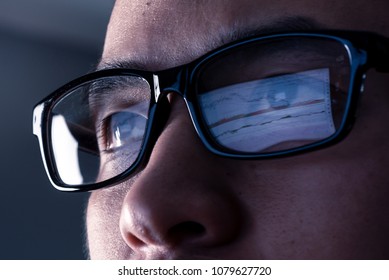 the abstract image of the businessman wear a glasses looking at the stock trading chart on the computer screen. the concept of business, technology, trading, information and internet of things.