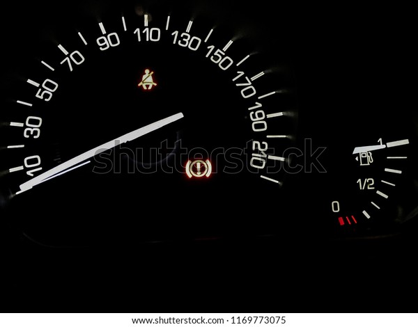 Abstract image of car dashboard with\
speedometer and fuel tank indicator in black\
colour