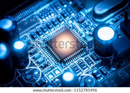 The abstract image of the chipset illumination on the computer mainboard. The concept of computer, hardware, futuristic, electronics and technology.