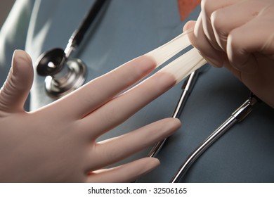 Abstract Image Of Doctor Taking Off Latex Surgical Gloves.