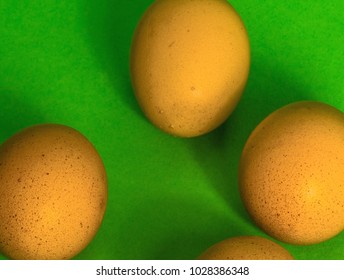 Abstract image of Easter, four incomplete eggs on a green background with soft shadows, concept