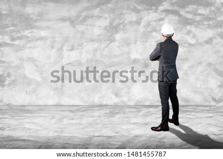 the abstract image of the engineer standing in the white empty room and copy space. tThe concept of engineering, construction, city life and future.