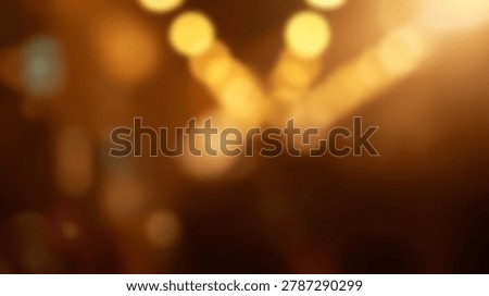 An abstract image featuring bokeh lights with golden and orange hues. The artistic blur creates a dreamy and vibrant atmosphere, perfect for backgrounds and artistic projects.