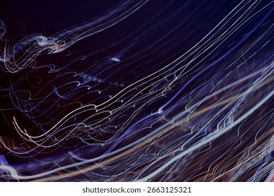 Abstract image featuring dynamic light trails in motion, creating a sense of speed and energy. The vibrant colors contrast against the dark background, enhancing the visual impact.