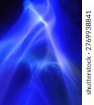 An abstract image featuring swirling patterns of bright blue light against a dark background, creating a sense of energy and movement.