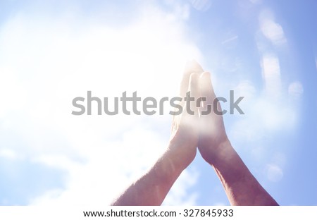 abstract image of male hands reaching for the sky. room for text. double exposure.