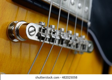 An abstract image of the metal strings on a bass guitar.