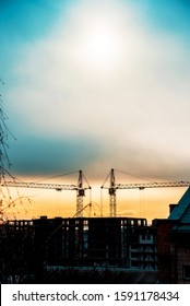 Abstract Image Of A Pair Of Construction Cranes On A Sunrise Background (progress, Lower Mortgage Rates, Falling House Prices - Concept)