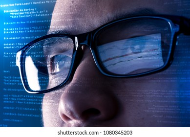 The Abstract Image Of The Programmer Wear A Glasses Looking At The Source Code And Chart On The Computer Screen. The Concept Of Programming, Cyber Security, Business, City Life And Internet Of Things