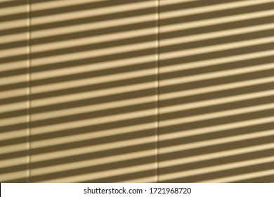 Abstract image from the shadows of window blinds on a white wall. 