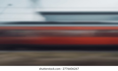 Abstract image of a speeding train, captured with a motion blur effect, conveying speed and travel. The trains red and white colors are visible.