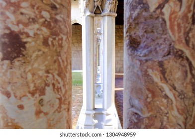 Abstract image of stone columns. Looking through archway columns. Interior design and detail. 