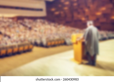 Abstract Image Of Student Holding Valedictorian Speech At Graduation Ceremony. Intentionally Blurred In Post Processing.