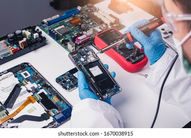 The abstract image of the technician assembling inside of smartphone by screwdriver in the lab. the concept of computer hardware, mobile phone, electronic, repairing, upgrade and technology.