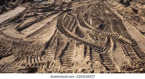 abstract image of tire tracks of construction vehicles in sand on a construction site - Powered by Shutterstock