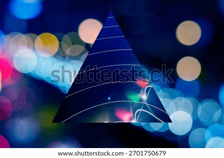 Abstract image with a triangle overlay on a bokeh background. The triangle and bokeh create a dynamic, colorful effect. Triangle and bokeh blend artistically. Christmas holiday image.