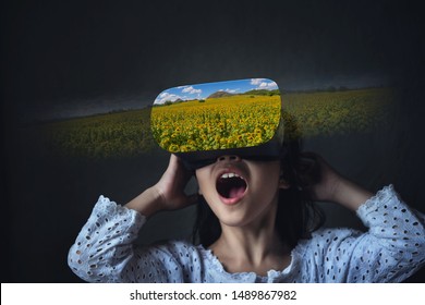 Abstract image of virtual reality experience, asia girl white shirt in VR glasses looking amazing sun flower field on black background. internet of things metaverse technology network globalization.