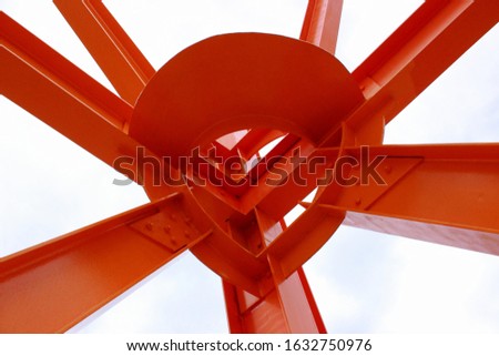 Abstract image of a welded metal beams structure against clear sky background