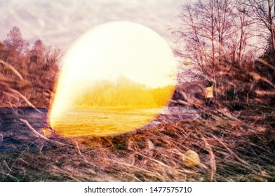 Abstract Image. Yellow Balloon And A Boy In A Yellow T-shirt On The River. Expired Experimental Film With Grain Texture, Multiple Exposure. Retro Negative Film Look.