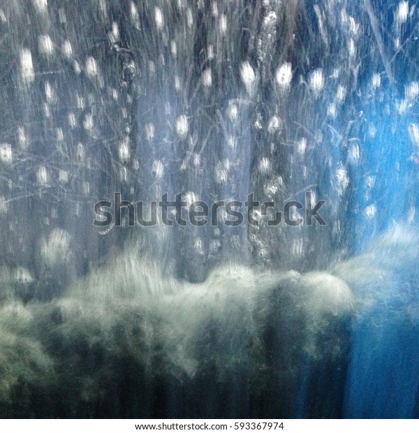 Abstract from inside a car wash, blurred image\
of brushes and soapy water on the\
screen